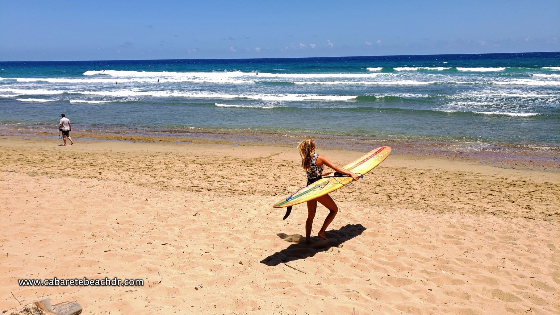 Blonde woman with surfboards