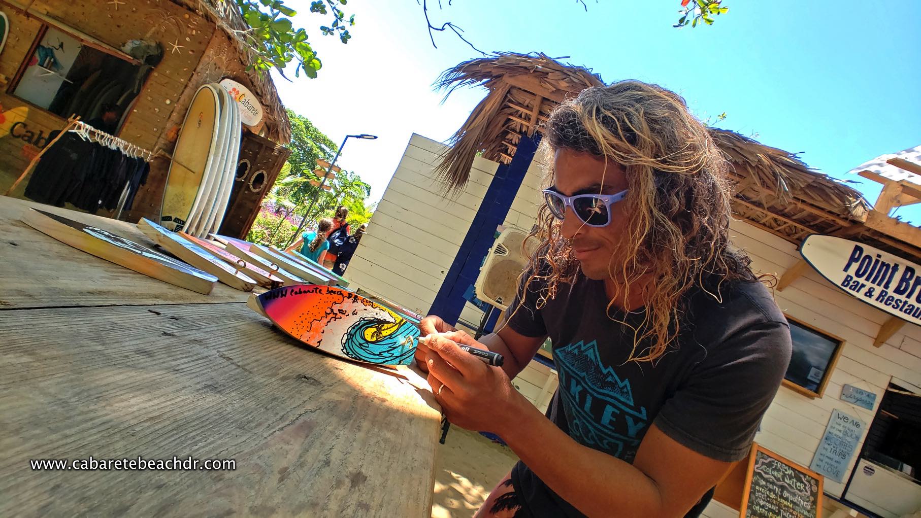 A handcraft expert painting souvenirs in the beach