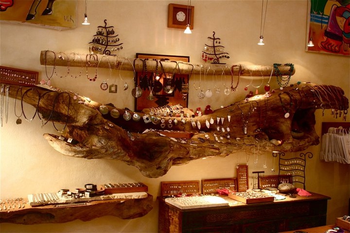 Jewelry displayed on driftwood